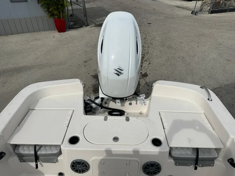 Slide: The Image of 2025 Carolina Skiff 21 LS boat with Suzuki outboard motor, rear deck view. - 14