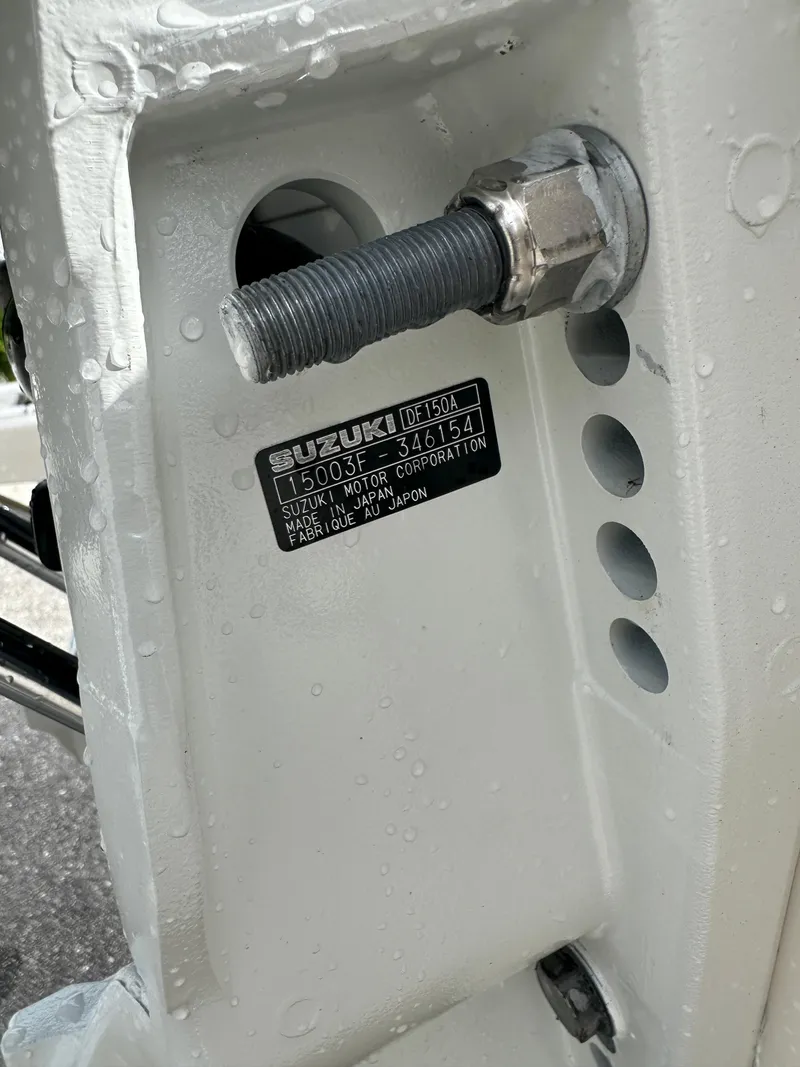 Slide: The Image of Close-up of a 2025 Carolina Skiff 21 LS boat motor mount with Suzuki label. - 17