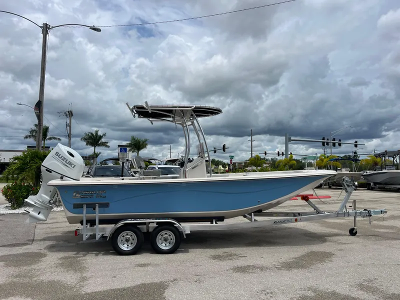 Slide: The Image of 2025 Carolina Skiff 21 LS boat on trailer under cloudy sky. - 2