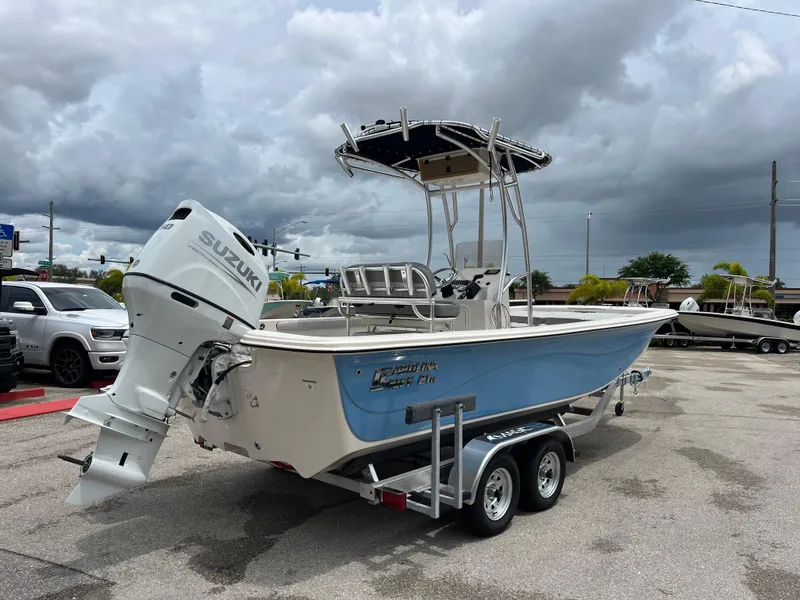Slide: The Image of 2025 Carolina Skiff 21 LS boat on trailer, featuring Suzuki outboard motor. - 3