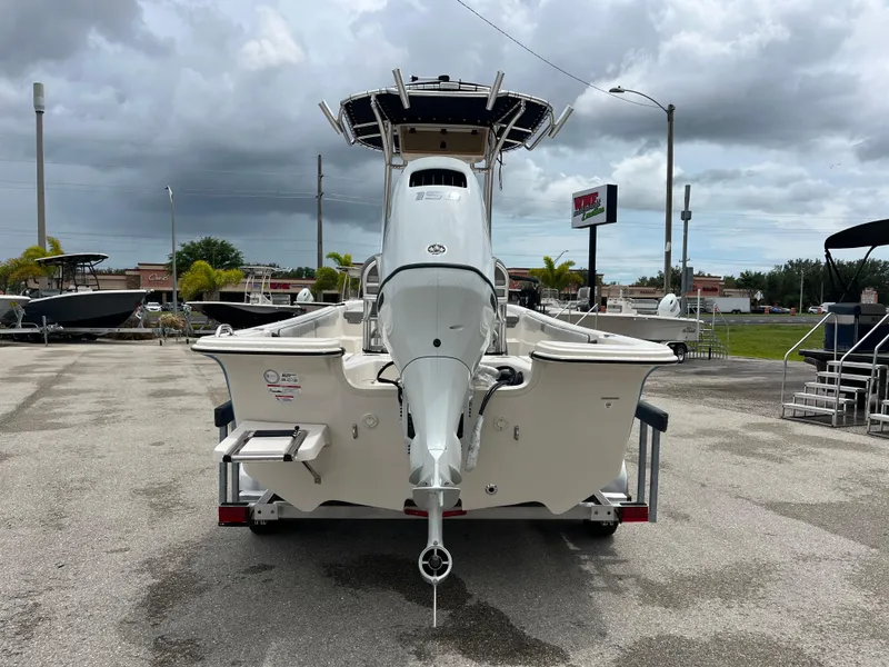 Slide: The Image of 2025 Carolina Skiff 21 LS boat on trailer, parked outdoors under cloudy sky. - 4