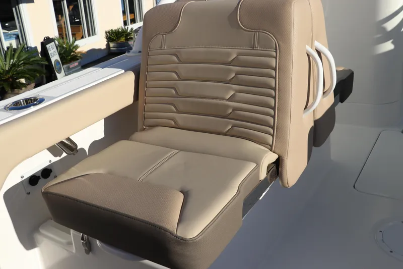 Slide: The Image of 2025 Edgewater 248 CX boat seat, beige upholstery, foldable design. - 11