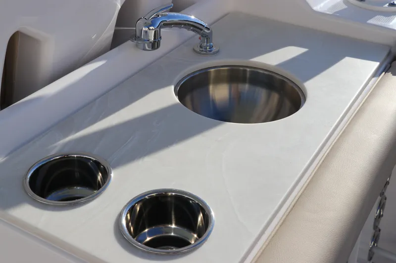 Slide: The Image of 2025 Edgewater 248 CX boat interior with sink and cup holders. - 16