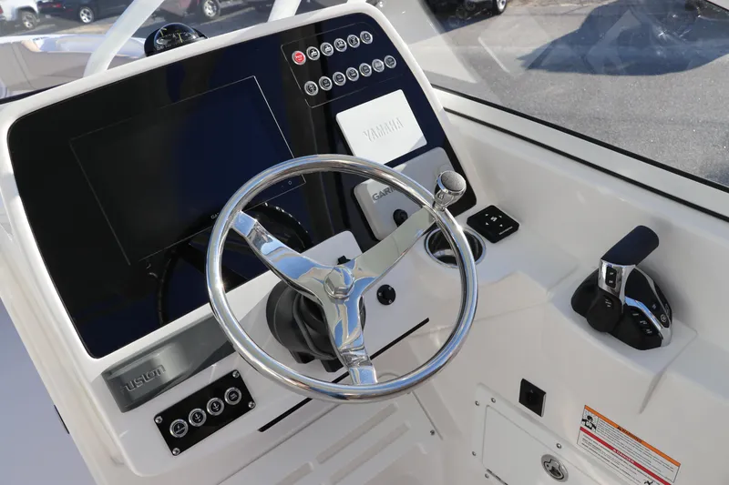 Slide: The Image of Luxurious captain's chair on 2025 Edgewater 248 CX boat, featuring cup holders and sleek design. - 22