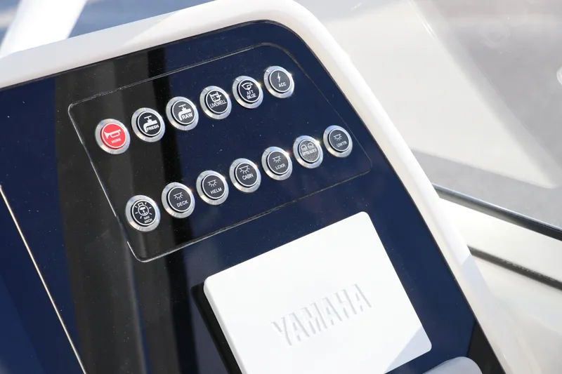 Slide: The Image of 2025 Edgewater 248 CX boat dashboard with steering wheel and controls. - 23