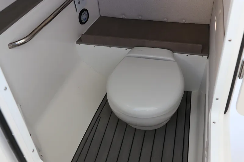 Slide: The Image of 2025 Edgewater 248 CX boat interior with sleek white finish and storage compartment. - 30