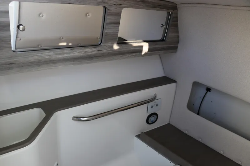 Slide: The Image of 2025 Edgewater 248 CX boat interior with a compact marine toilet. - 31