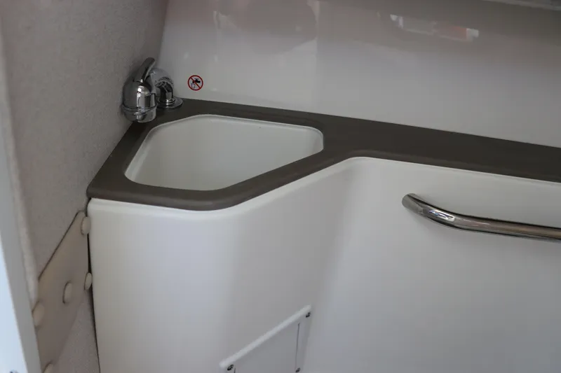 Slide: The Image of Interior of 2025 Edgewater 248 CX boat, featuring sleek storage and modern design. - 32