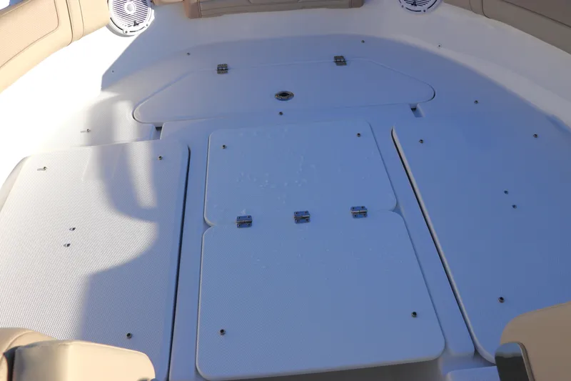 Slide: The Image of Edgewater 248 CX 2025 boat cup holder and storage compartment lid. - 39