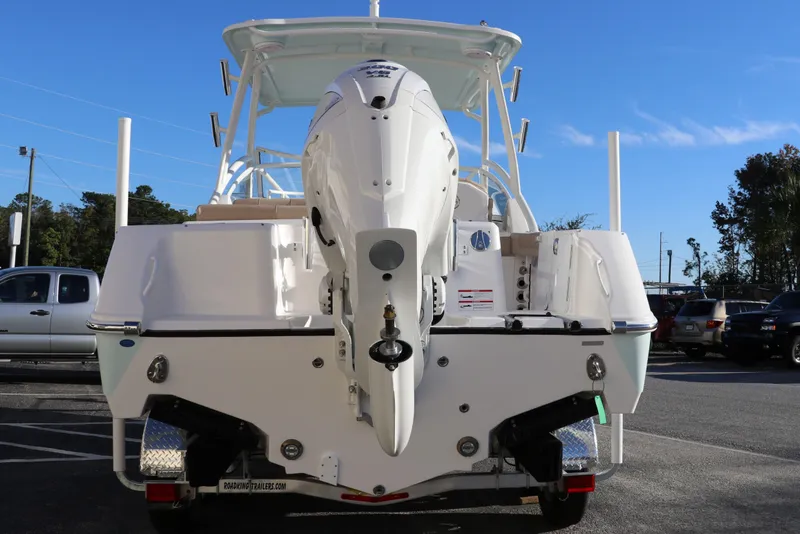 Slide: The Image of 2025 Edgewater 248 CX boat on trailer under bright sun. - 4