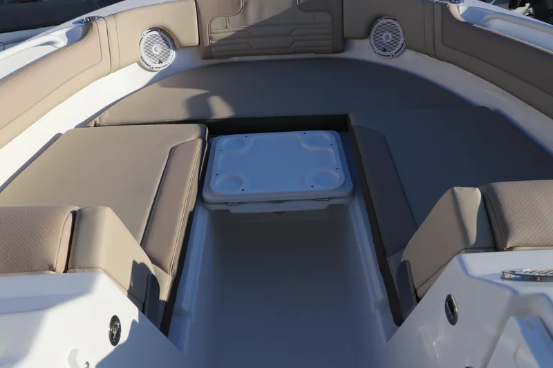 Slide: The Image of Edgewater 248 CX 2025 boat interior with beige seating and cup holder. - 43