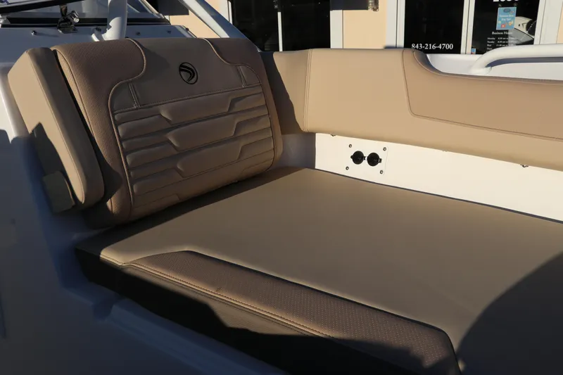 Slide: The Image of 2025 Edgewater 248 CX boat interior with cushioned seating and built-in speakers. - 45