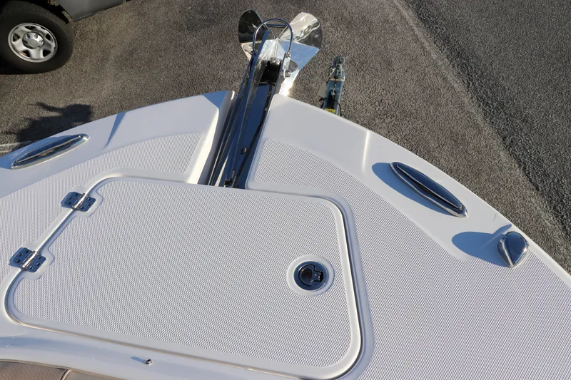 Slide: The Image of 2025 Edgewater 248 CX boat interior with cushioned seating and built-in speakers. - 48