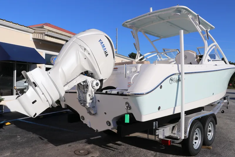 Slide: The Image of 2025 Edgewater 248 CX boat on trailer, featuring powerful outboard motor. - 5