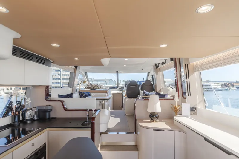 Slide: The Image of Luxurious interior of 2022 Azimut 55 Fly yacht with modern kitchen and seating area. - 13