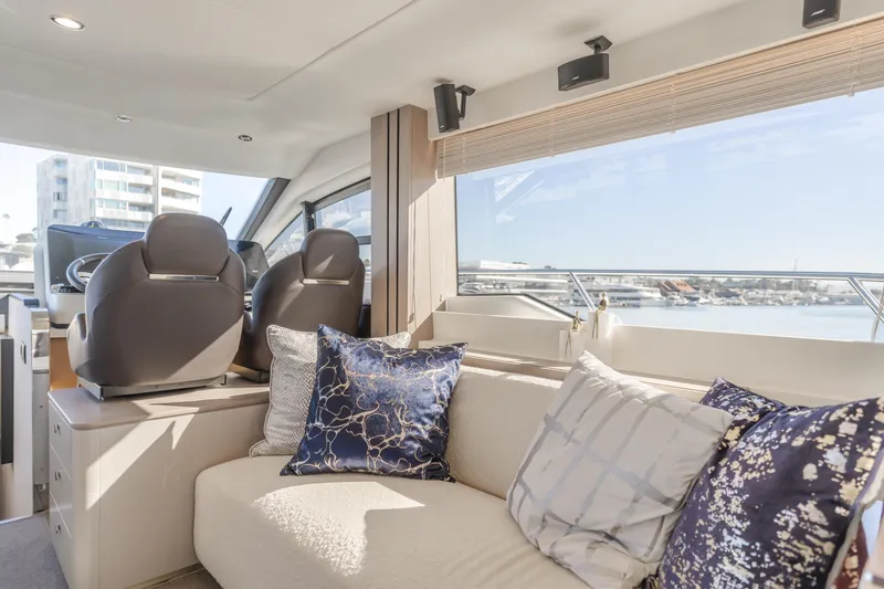 Slide: The Image of Luxurious interior of 2022 Azimut 55 Fly yacht with plush seating and scenic views. - 17