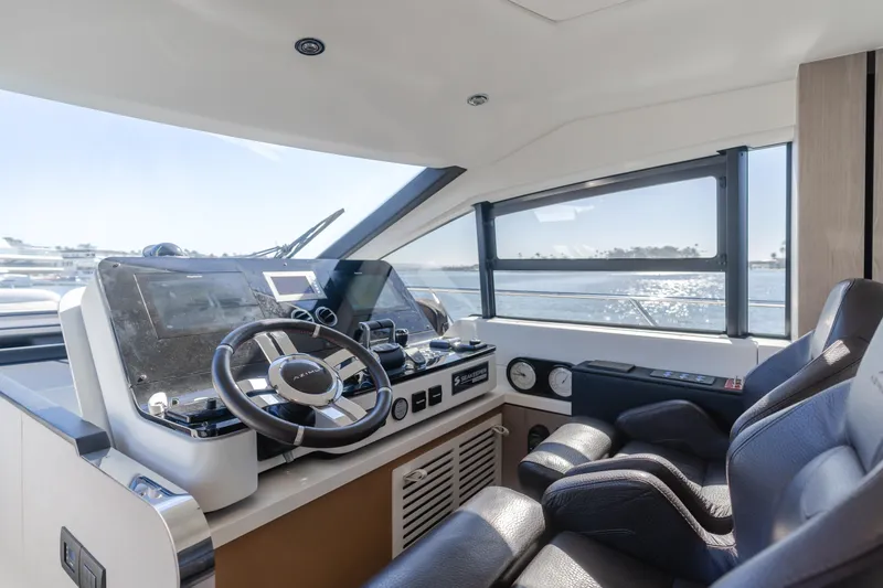 Slide: The Image of Interior helm of 2022 Azimut 55 Fly yacht with modern controls and ocean view. - 19