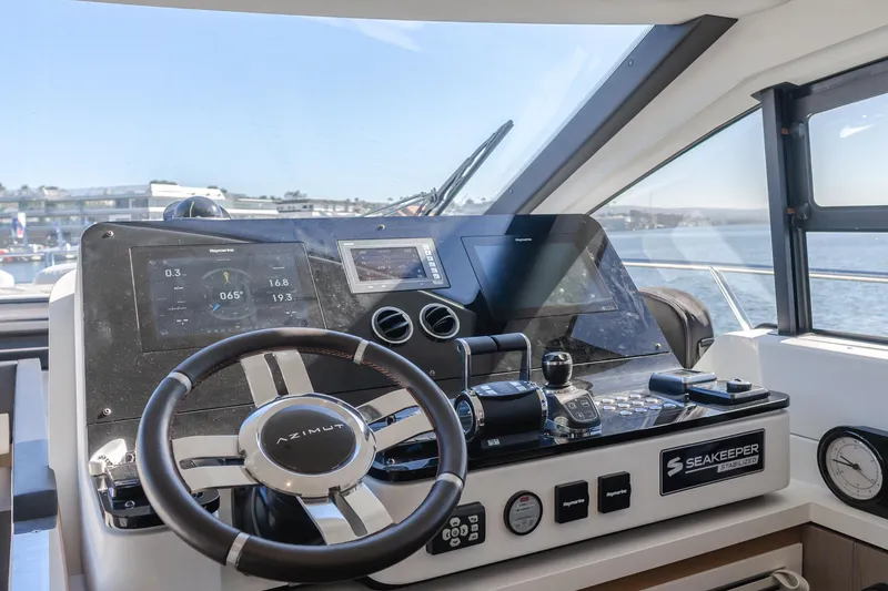 Slide: The Image of Azimut 55 Fly 2022 yacht helm with modern navigation controls and Seakeeper system. - 20