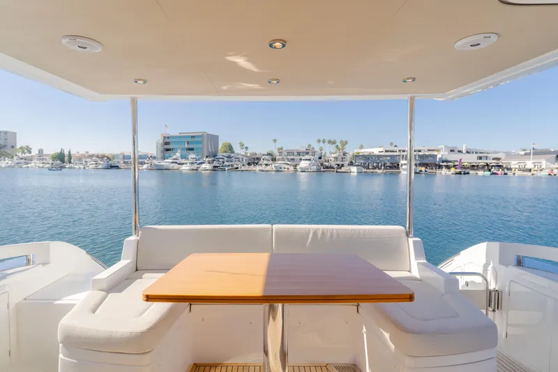 Slide: The Image of Azimut 55 Fly 2022 yacht with elegant seating and scenic marina view. - 21