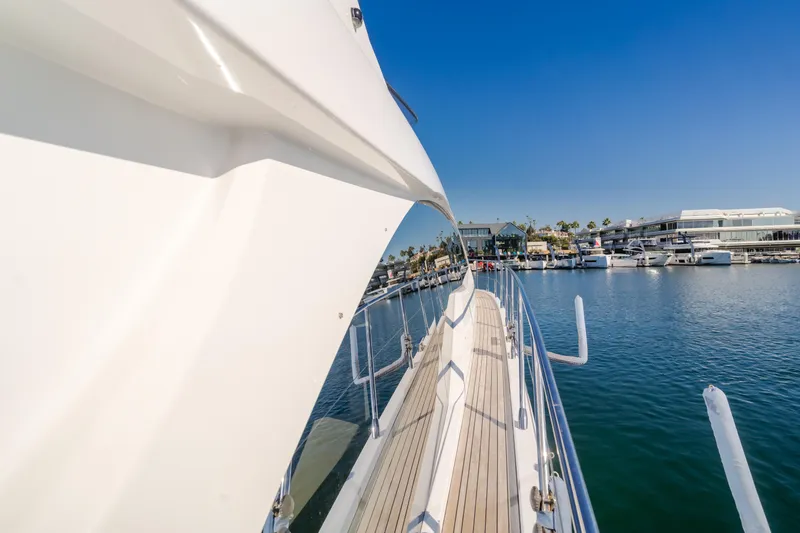 Slide: The Image of Azimut 55 Fly 2022 yacht deck view, marina background, clear blue sky. - 22