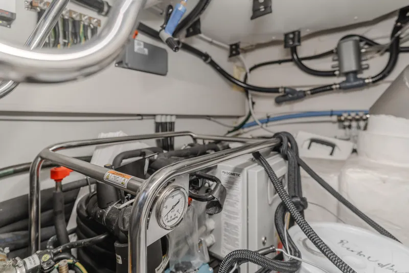Slide: The Image of Engine room of 2022 Azimut 55 Fly yacht with visible machinery and wiring. - 27