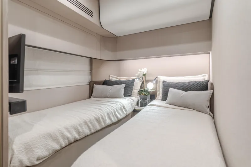Slide: The Image of Luxurious twin bedroom in 2022 Azimut 55 Fly yacht, featuring modern decor and cozy bedding. - 30