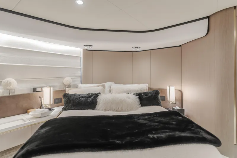 Slide: The Image of Luxurious bedroom interior of 2022 Azimut 55 Fly yacht, featuring elegant bedding and modern lighting. - 37