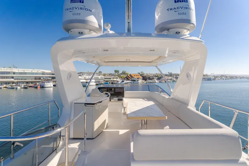 Slide: The Image of Azimut 55 Fly 2022 yacht flybridge with seating, table, and ocean view. - 42