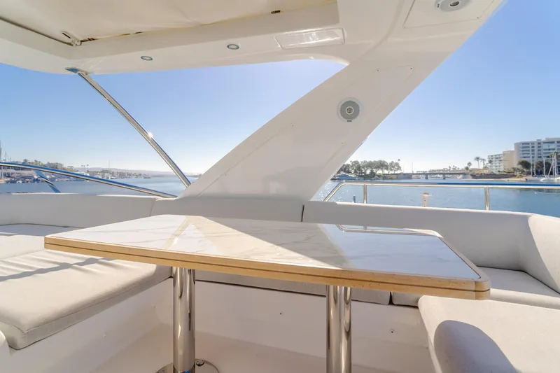 Slide: The Image of Luxurious seating area on 2022 Azimut 55 Fly yacht with scenic waterfront view. - 44