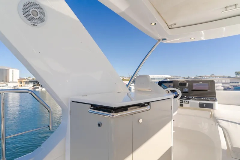 Slide: The Image of Luxurious 2022 Azimut 55 Fly yacht cockpit with modern controls and ocean view. - 45