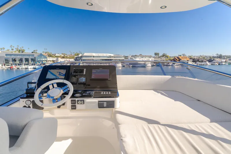 Slide: The Image of Flybridge of 2022 Azimut 55 Fly yacht with modern controls and waterfront view. - 47