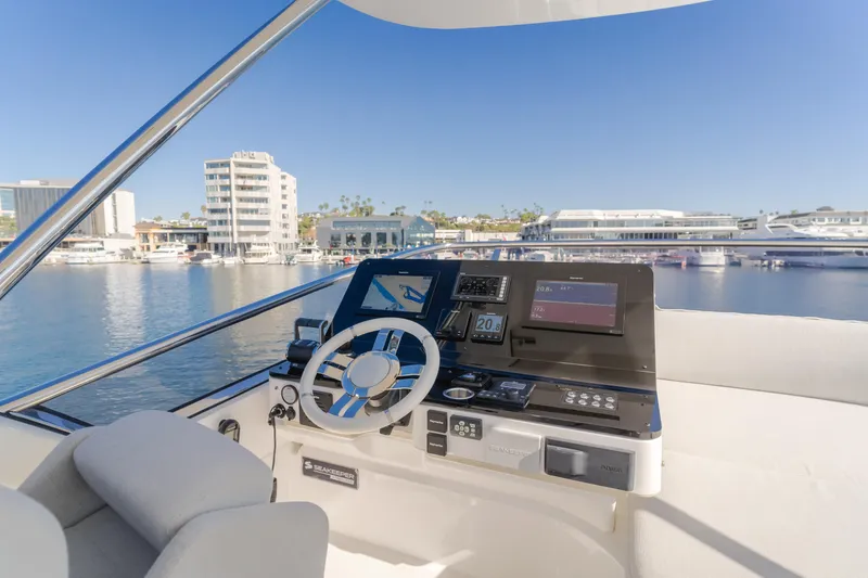 Slide: The Image of Flybridge helm of 2022 Azimut 55 Fly yacht with marina view. - 48