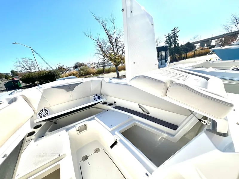 Slide: The Image of 2025 Sailfish 276 DC boat interior with white seating and storage compartments. - 10