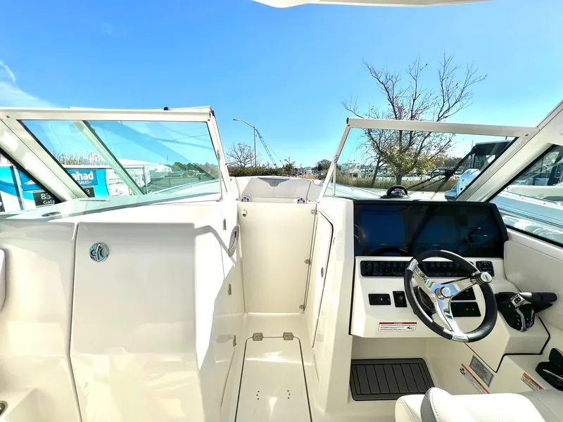Slide: The Image of 2025 Sailfish 276 DC boat cockpit with modern steering and dashboard. - 13
