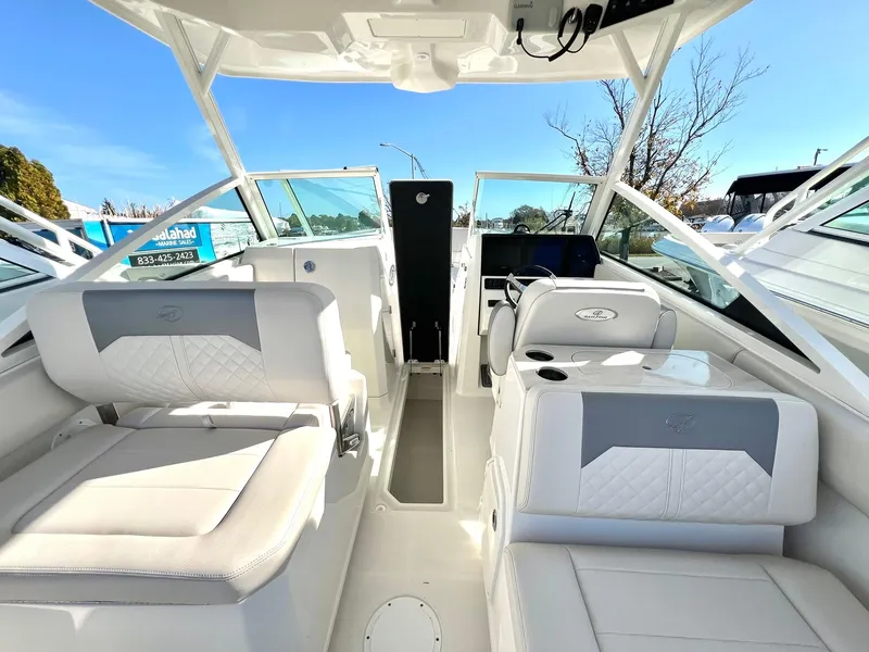 Slide: The Image of 2025 Sailfish 276 DC boat interior with white seating and modern design. - 14
