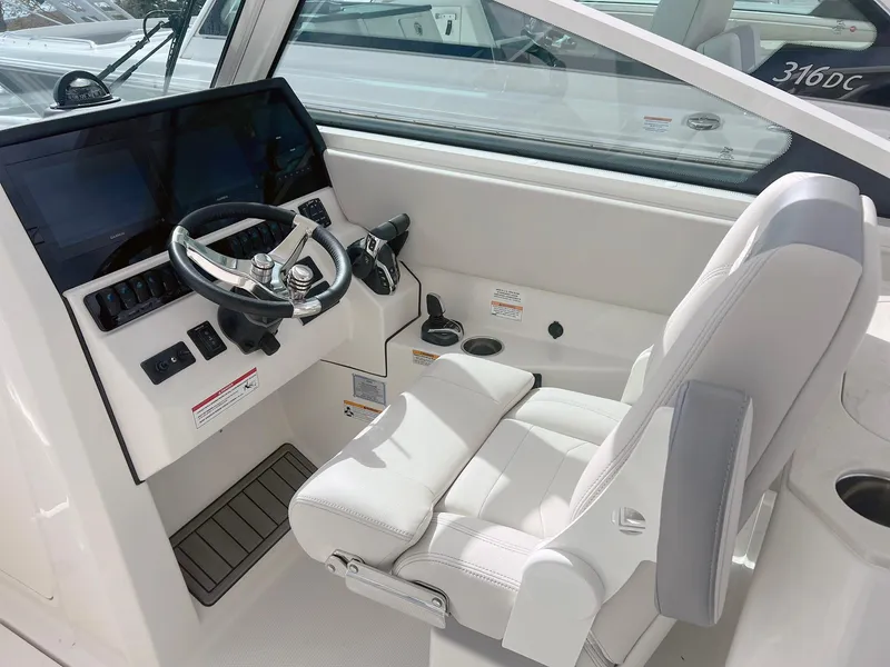 Slide: The Image of 2025 Sailfish 276 DC boat cockpit with modern steering and controls. - 21