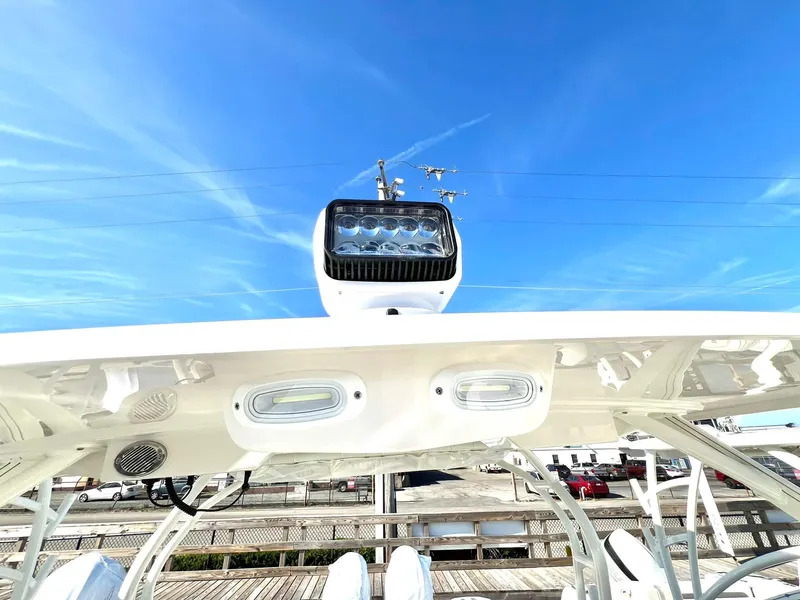Slide: The Image of 2025 Sailfish 276 DC boat spotlight against clear blue sky. - 24
