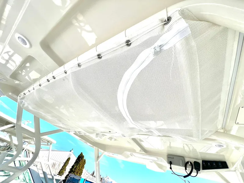 Slide: The Image of 2025 Sailfish 276 DC boat canopy with mesh netting and control panel. - 25
