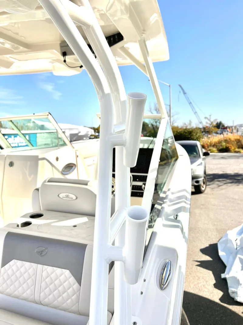 Slide: The Image of 2025 Sailfish 276 DC boat with sleek white interior and rod holders. - 26