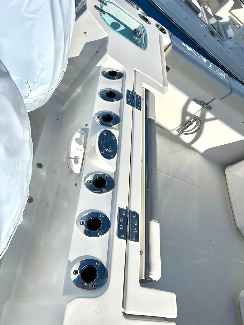 Slide: The Image of 2025 Sailfish 276 DC boat interior with rod holders and storage compartments. - 27
