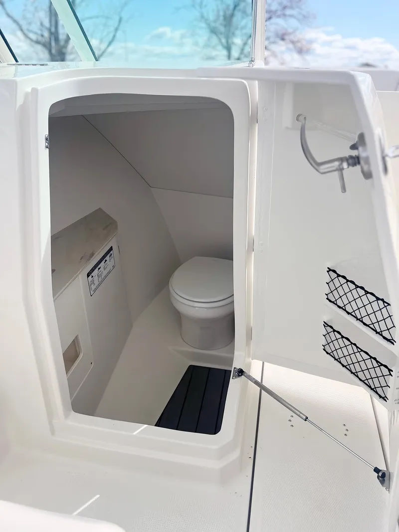 Slide: The Image of 2025 Sailfish 276 DC boat interior with compact marine toilet. - 28