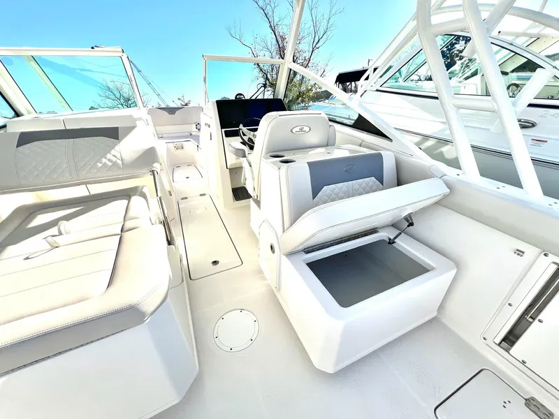 Slide: The Image of 2025 Sailfish 276 DC boat interior with white seating and storage compartments. - 32