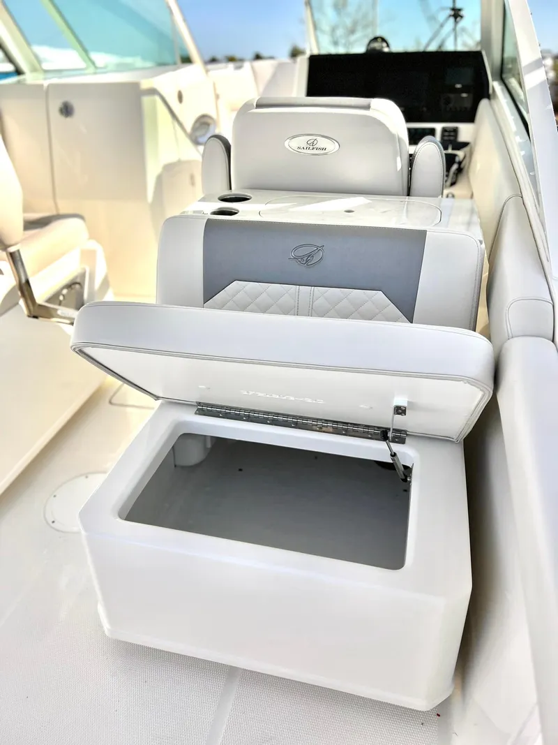 Slide: The Image of 2025 Sailfish 276 DC boat interior with open storage compartment and cushioned seating. - 37