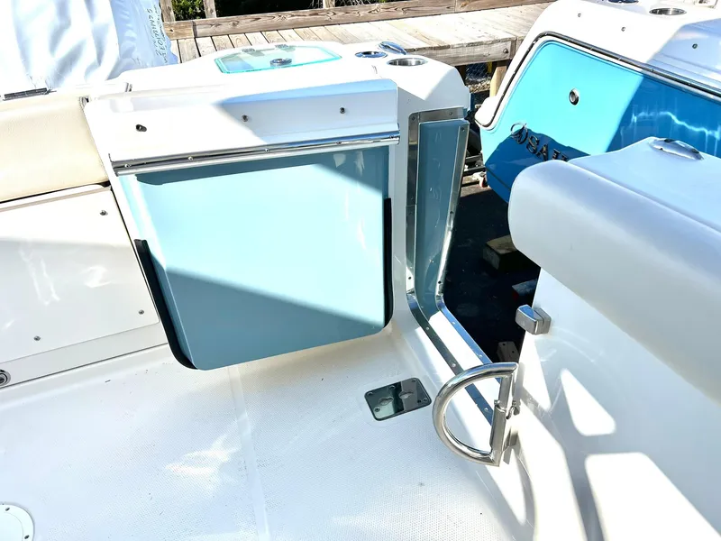 Slide: The Image of 2025 Sailfish 276 DC boat interior with blue accents and seating area. - 38