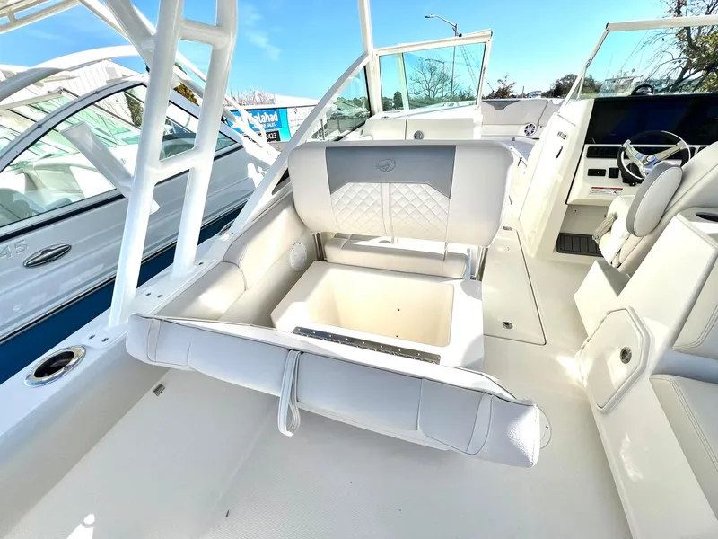 Slide: The Image of 2025 Sailfish 276 DC boat interior with white seating and storage compartment. - 39