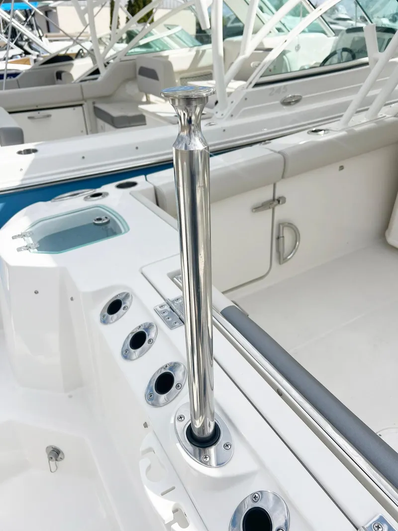 Slide: The Image of 2025 Sailfish 276 DC boat interior with rod holders and seating. - 43