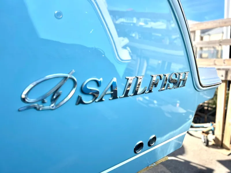 Slide: The Image of Close-up of 2025 Sailfish 276 DC boat logo on blue hull. - 45