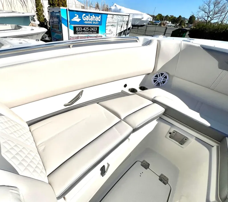Slide: The Image of 2025 Sailfish 276 DC boat interior with white seating and speaker. - 5