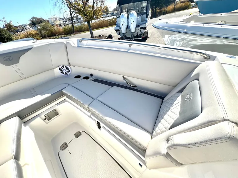 Slide: The Image of 2025 Sailfish 276 DC boat interior with white cushioned seating and storage compartments. - 6
