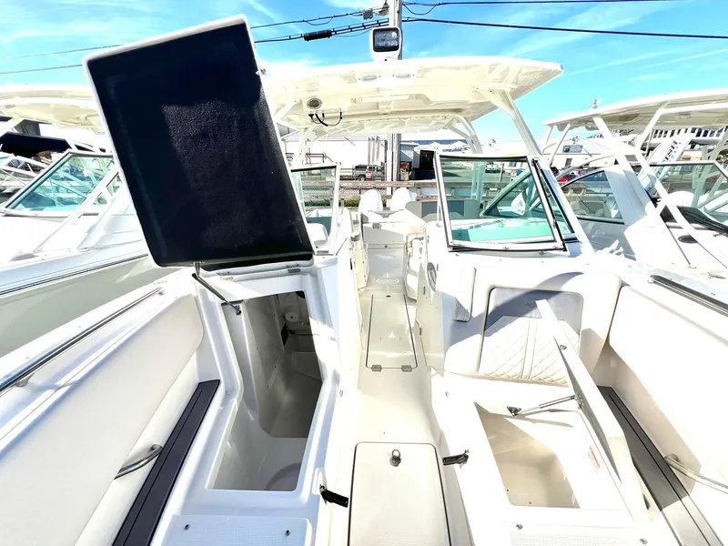 Slide: The Image of 2025 Sailfish 276 DC boat interior with open storage compartments and seating. - 8